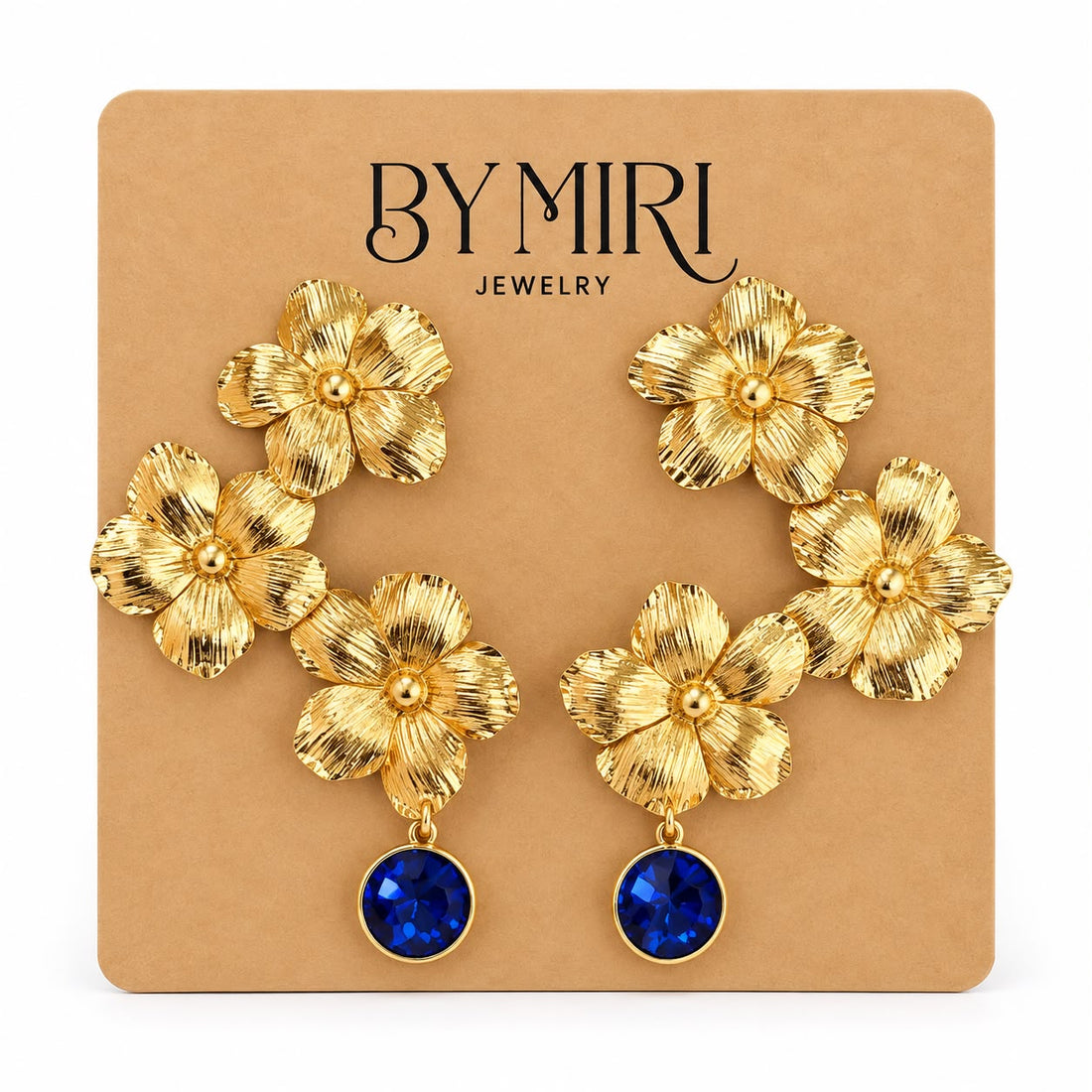 Aretes Jardín Zafiro con flores doradas texturizadas y cristal azul zafiro en la caída