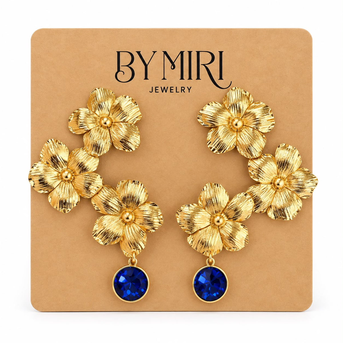Aretes Jardín Zafiro con flores doradas texturizadas y cristal azul zafiro en la caída